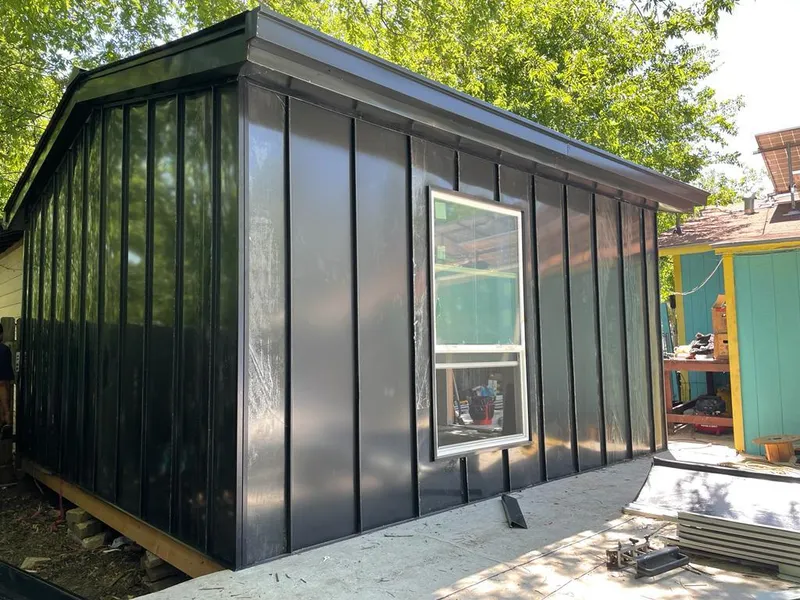 Black standing seam metal wall panels for Roof Inspection in Grafton